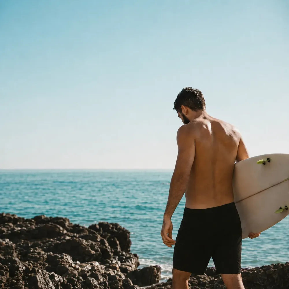 REYS bottle paired with sunscreen — wear both, every day